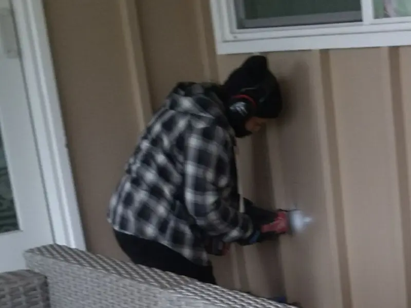 Professional electrician installing an exterior outlet in Round Rock