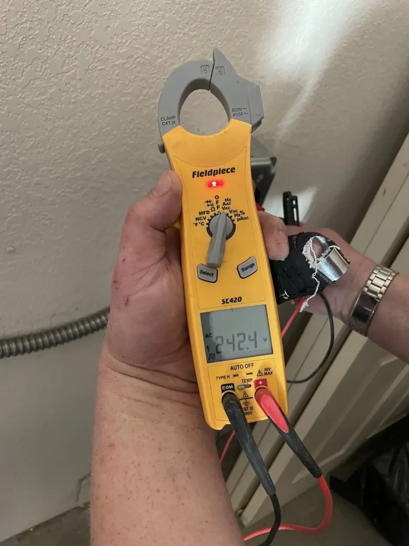 Voltage testing with clamp meter during Ceiling Fan Installation in Round Rock